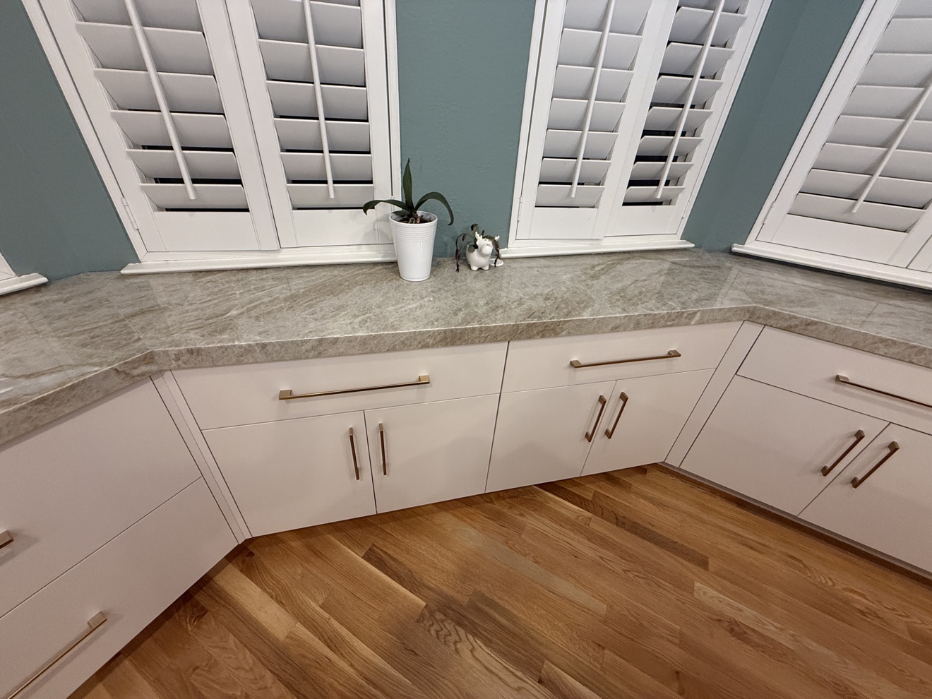 Kenwood St bay cabinetry in white flat-panel fronts beneath the windows