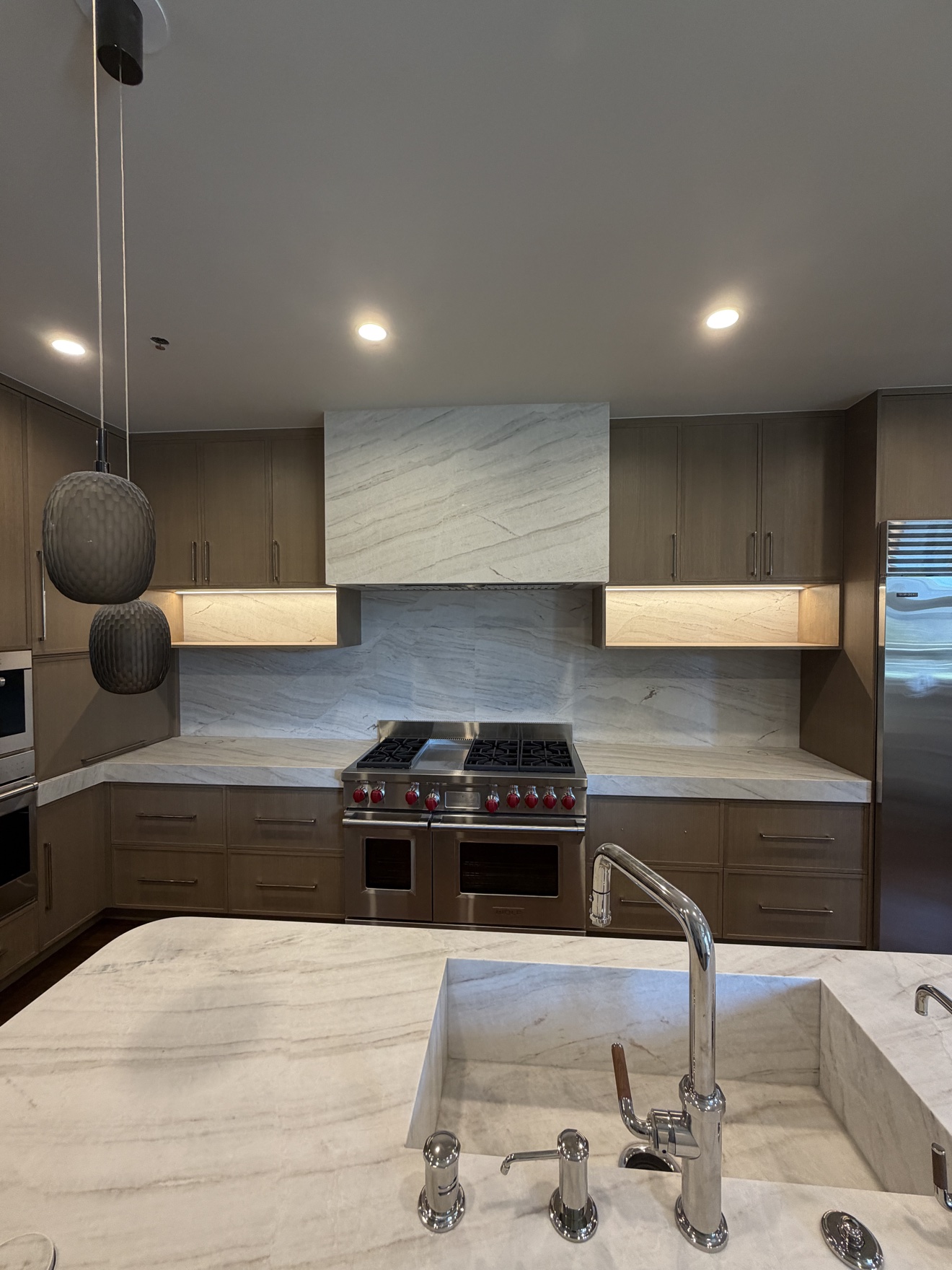 Parker range wall with dark frameless cabinets and stained white oak drawers