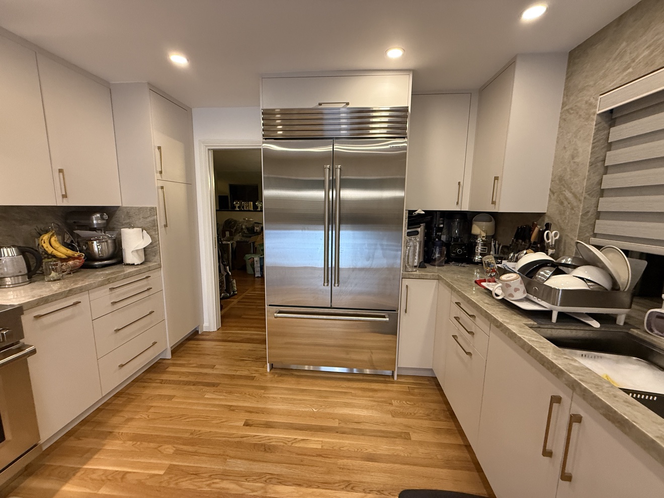 Kenwood St refrigerator wall in white European flat-panel cabinetry