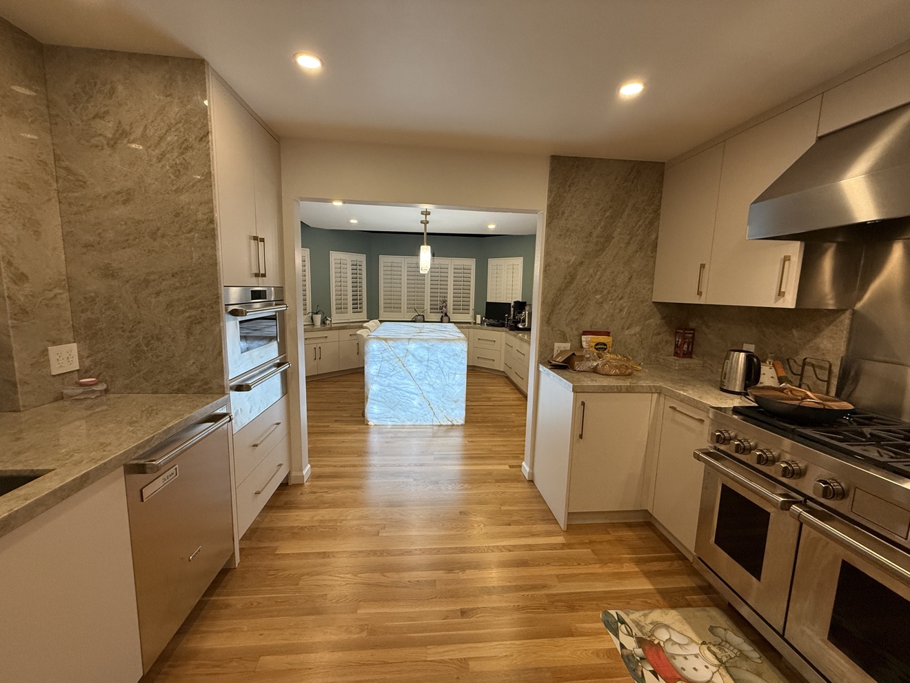 Kenwood St range wall with white flat-panel cabinetry and stainless range