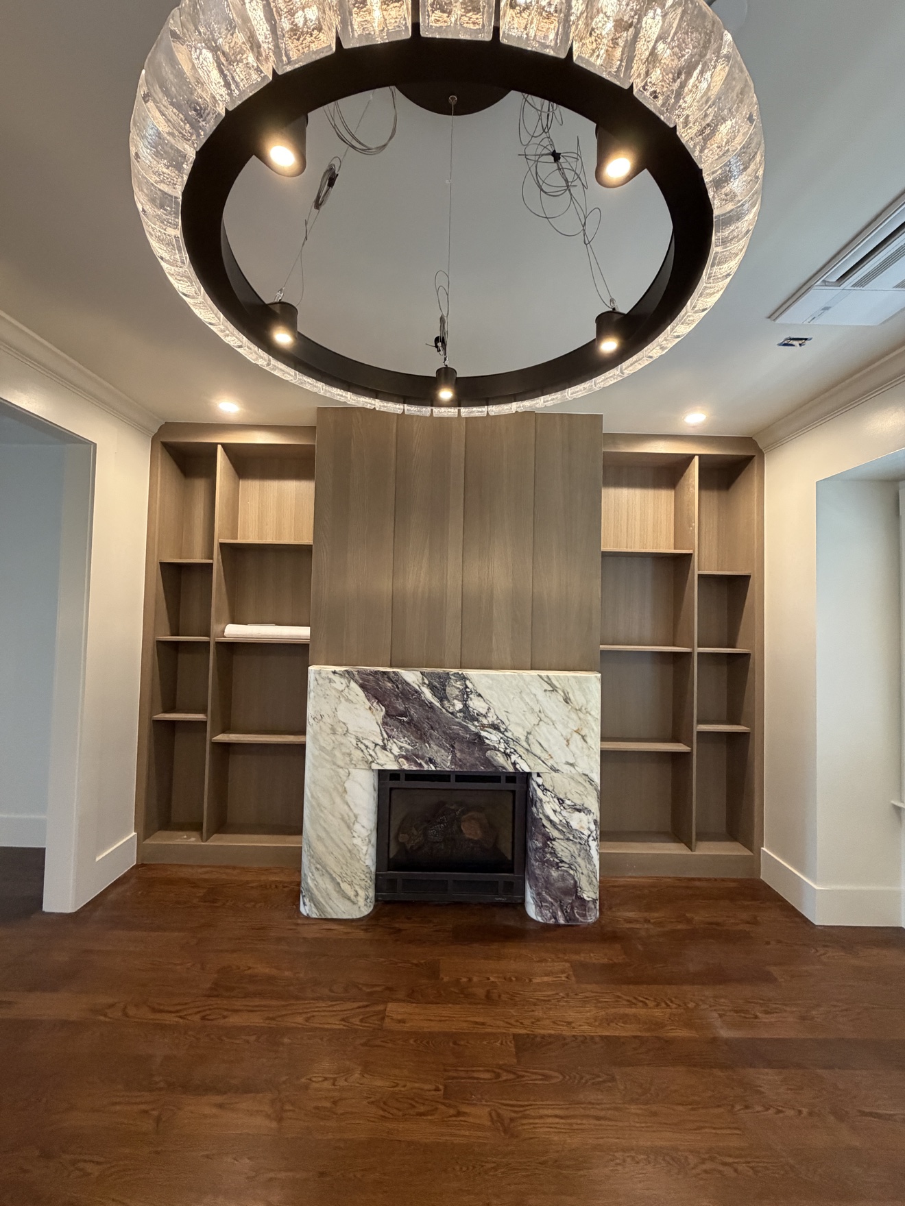 Parker fireplace built-ins with illuminated stained white oak display shelves