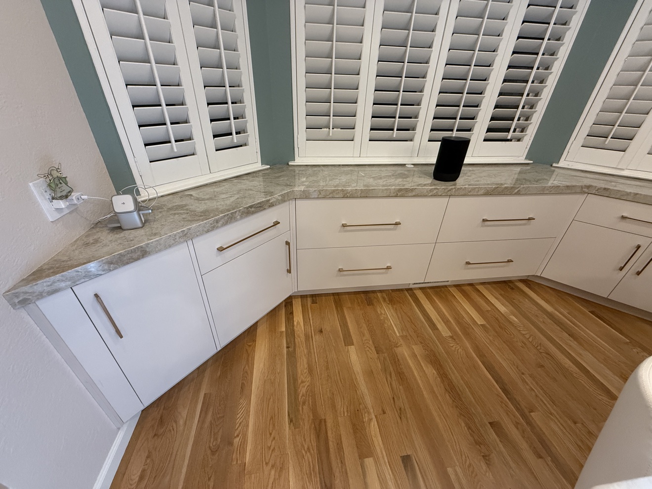 Kenwood St bay-window seating wrapped in white cabinet storage